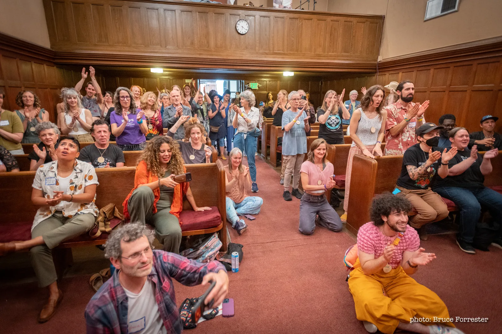 Festival attendees standing and applauding in the sanctuary at Our Freedom Festival